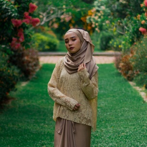Planted's founder, wearing a hijab over a knit sweater